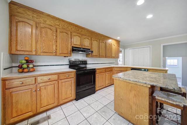1723 Baskins Hill Rd, Heath Springs, SC 29058 - kitchen with ornamental molding, a peninsula, under cabinet range hood, and black appliances