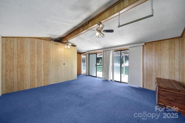1723 Baskins Hill Rd, Heath Springs, SC 29058 - unfurnished room featuring wooden walls, carpet flooring, a textured ceiling, a ceiling fan, and vaulted ceiling with beams