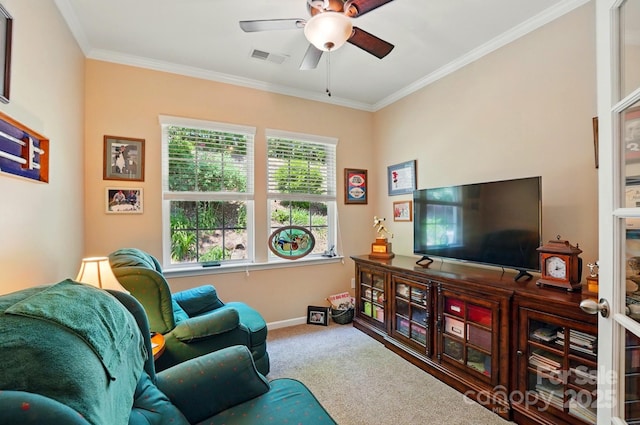 carpeted living room featuring crown molding, ceiling fan, visible vents, and baseboards