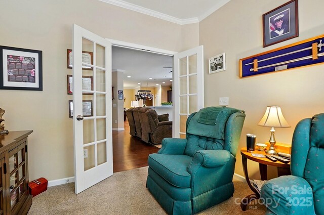 sitting room with carpet floors, baseboards, ornamental molding, and french doors