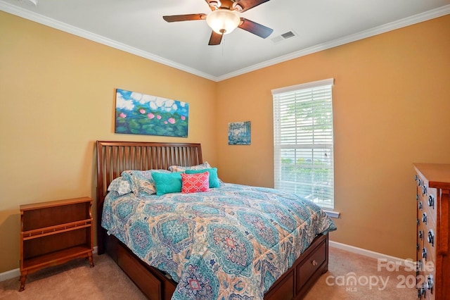 bedroom with crown molding, baseboards, visible vents, and light carpet