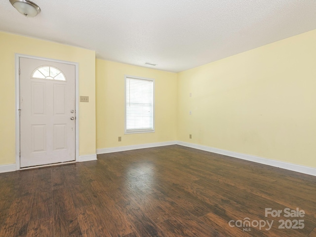 entrance foyer featuring baseboards and dark wood-style flooring