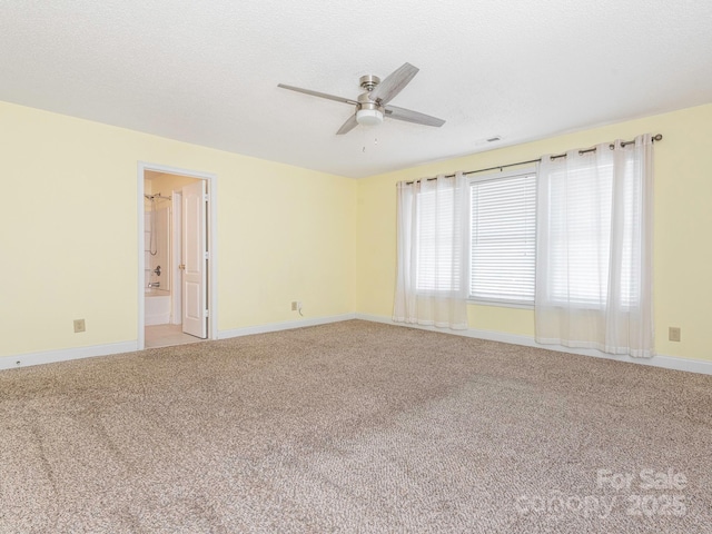 empty room featuring baseboards, a ceiling fan, and light colored carpet
