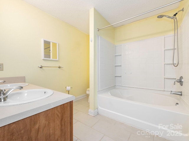 full bathroom with a sink, tile patterned flooring, toilet, a textured ceiling, and tub / shower combination