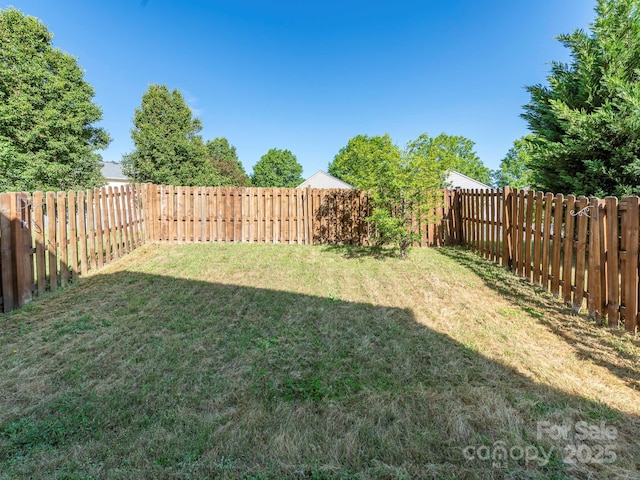 view of yard with a fenced backyard