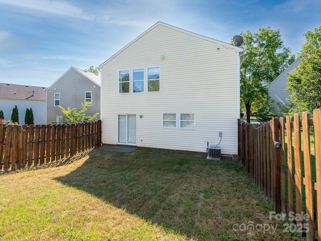 back of property with a yard, cooling unit, and a fenced backyard