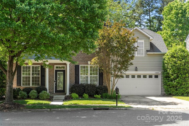 14625 Lyon Hill Ln, Huntersville, NC 28078 - obstructed view of property with brick siding, a garage, and concrete driveway