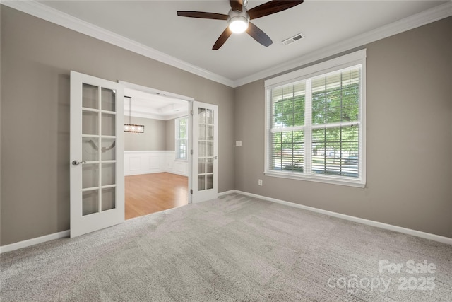 14625 Lyon Hill Ln, Huntersville, NC 28078 - spare room featuring crown molding, visible vents, french doors, carpet, and ceiling fan with notable chandelier