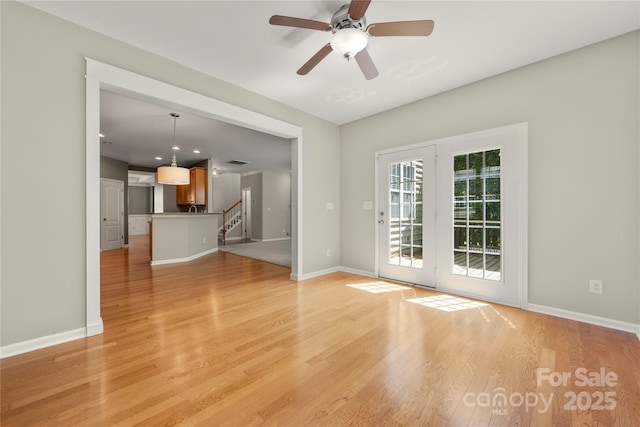 14625 Lyon Hill Ln, Huntersville, NC 28078 - unfurnished living room with light wood-type flooring, baseboards, and stairway