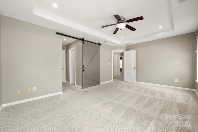 14625 Lyon Hill Ln, Huntersville, NC 28078 - unfurnished bedroom with recessed lighting, a tray ceiling, light colored carpet, and a barn door
