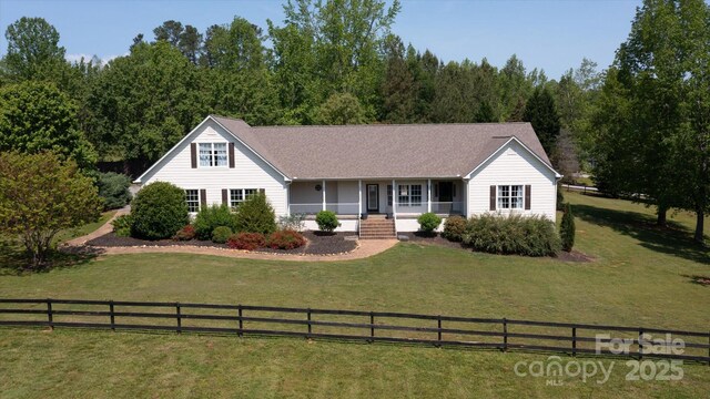 ranch-style home featuring fence private yard, a porch, and a front yard