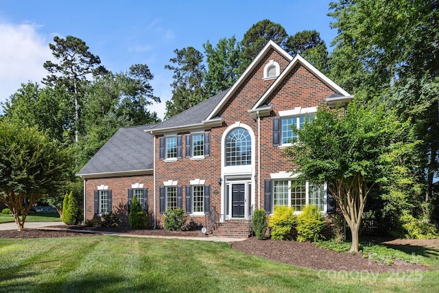 2608 Carmarthen Ct, Matthews, NC 28104 - view of front of property with brick siding, a front lawn, and a shingled roof