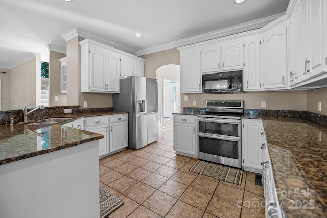 2608 Carmarthen Ct, Matthews, NC 28104 - kitchen featuring stainless steel appliances, crown molding, arched walkways, recessed lighting, and white cabinetry