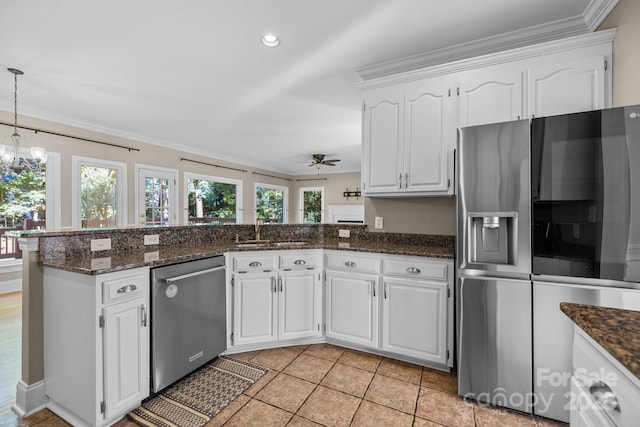 2608 Carmarthen Ct, Matthews, NC 28104 - kitchen with stainless steel appliances, ornamental molding, ceiling fan, white cabinetry, and a peninsula