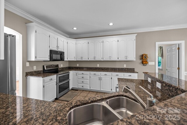 2608 Carmarthen Ct, Matthews, NC 28104 - kitchen featuring appliances with stainless steel finishes, ornamental molding, white cabinets, recessed lighting, and dark stone counters
