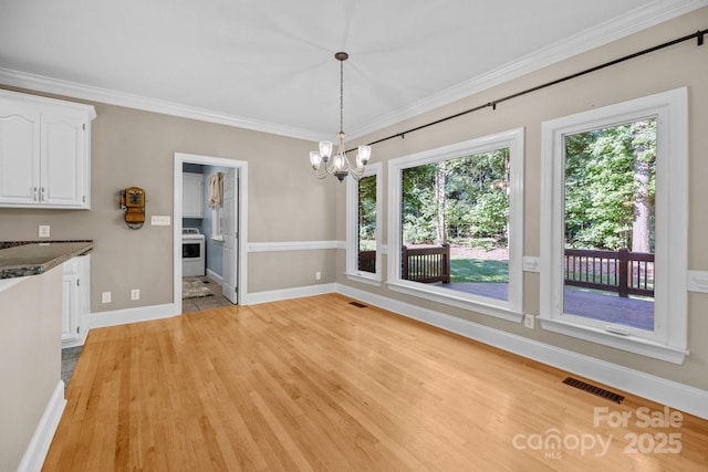 2608 Carmarthen Ct, Matthews, NC 28104 - unfurnished dining area with a chandelier, light wood-style flooring, and crown molding