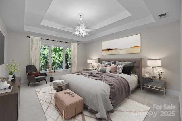 2608 Carmarthen Ct, Matthews, NC 28104 - bedroom with a tray ceiling and light carpet