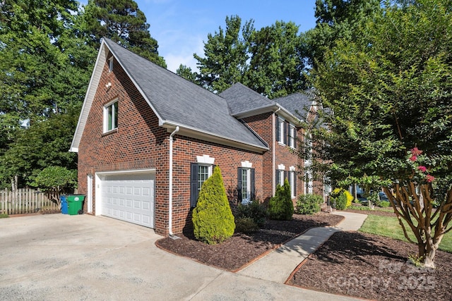 2608 Carmarthen Ct, Matthews, NC 28104 - view of home's exterior featuring a garage, brick siding, a shingled roof, and driveway