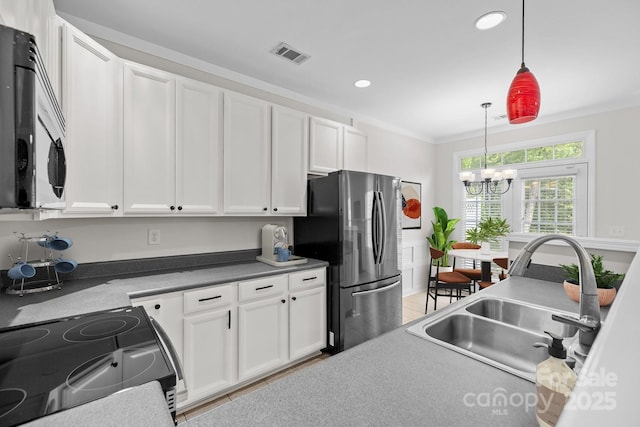 104 Clydesdale Ct, Matthews, NC 28104 - kitchen with appliances with stainless steel finishes, a chandelier, white cabinetry, pendant lighting, and recessed lighting
