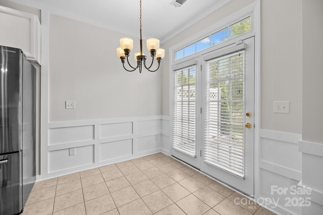 104 Clydesdale Ct, Matthews, NC 28104 - unfurnished dining area with a chandelier, light tile patterned floors, and wainscoting