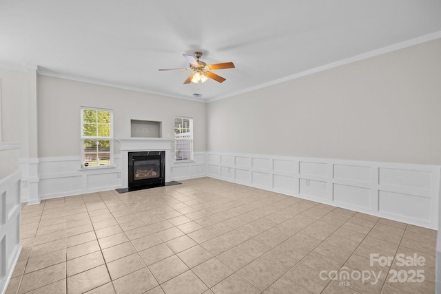 104 Clydesdale Ct, Matthews, NC 28104 - unfurnished living room featuring a decorative wall, a glass covered fireplace, light tile patterned floors, ceiling fan, and ornamental molding
