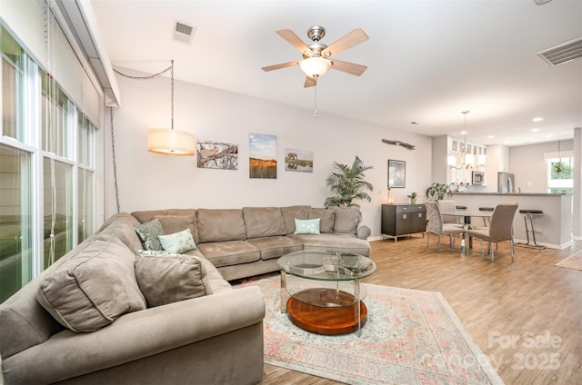 15318 Coventry Court Ln, Charlotte, NC 28277 - living room featuring ceiling fan with notable chandelier, recessed lighting, baseboards, light wood-type flooring, and visible vents