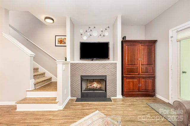 15318 Coventry Court Ln, Charlotte, NC 28277 - living room with stairs, baseboards, a tiled fireplace, and wood finished floors