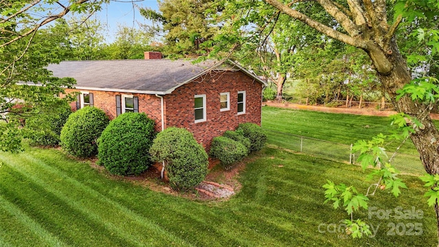 326 N Greenbriar Rd, Statesville, NC 28625 - view of side of home featuring fence, roof with shingles, brick siding, a chimney, and a lawn