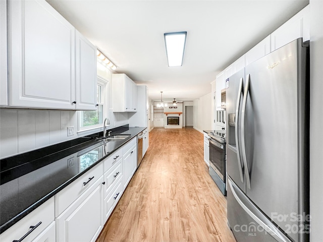326 N Greenbriar Rd, Statesville, NC 28625 - kitchen with white cabinets, appliances with stainless steel finishes, a sink, light wood-style flooring, and open floor plan
