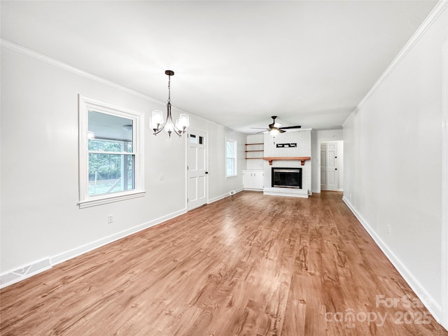 326 N Greenbriar Rd, Statesville, NC 28625 - unfurnished living room featuring crown molding, visible vents, a wealth of natural light, and ceiling fan with notable chandelier
