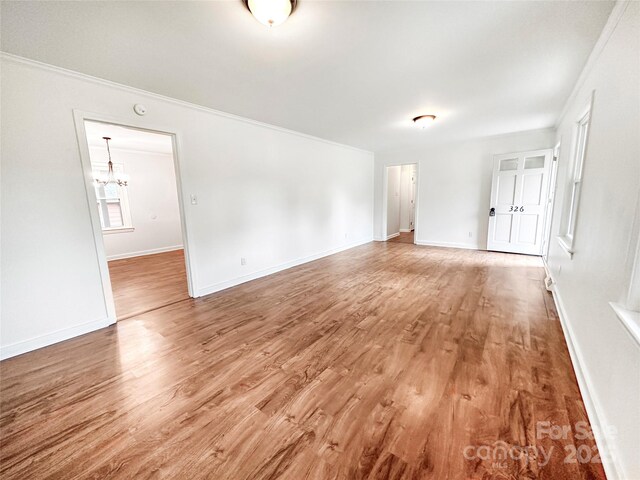 326 N Greenbriar Rd, Statesville, NC 28625 - empty room featuring an inviting chandelier, ornamental molding, light wood-style flooring, and baseboards