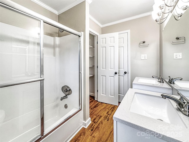 326 N Greenbriar Rd, Statesville, NC 28625 - bathroom with crown molding, vanity, a chandelier, wood finished floors, and bath / shower combo with glass door