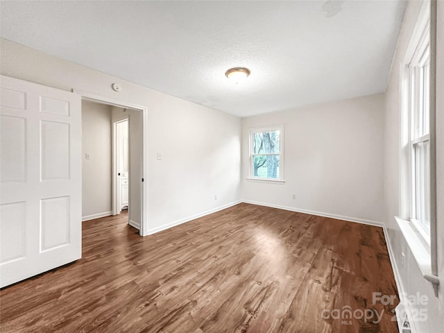 326 N Greenbriar Rd, Statesville, NC 28625 - unfurnished room with baseboards, a textured ceiling, and dark wood-style floors