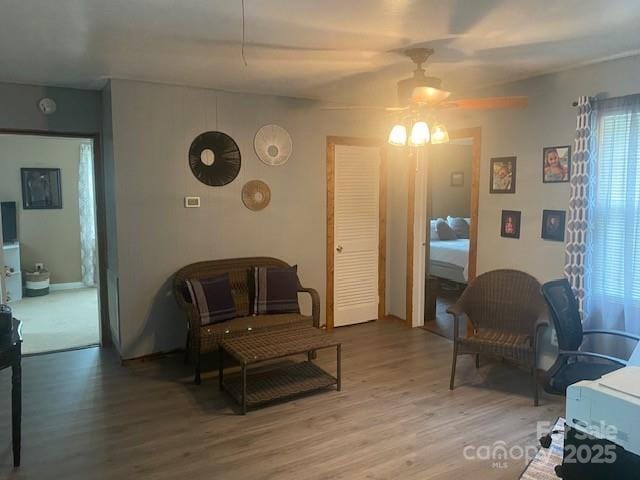 living area with a healthy amount of sunlight, a ceiling fan, and light wood finished floors