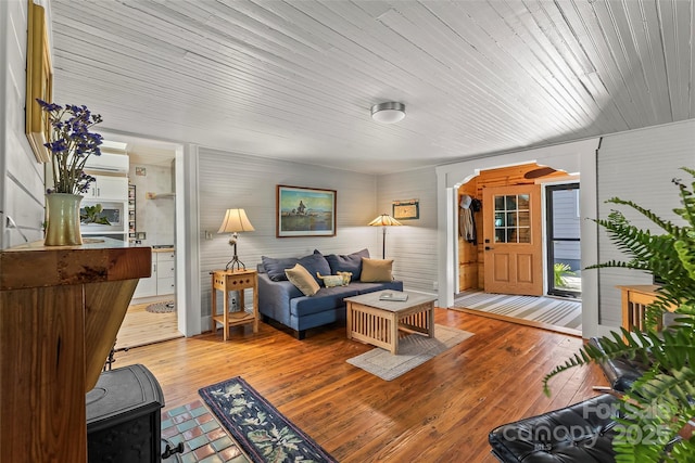 living area with light wood finished floors and a wall unit AC