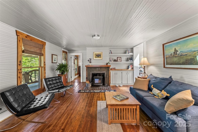 living area with wood walls, wood finished floors, and wooden ceiling