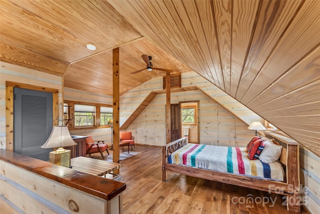 bedroom featuring wood walls, lofted ceiling, hardwood / wood-style floors, and wooden ceiling
