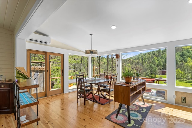 101 Garrison Rd, Mars Hill, NC 28754 - sunroom featuring an AC wall unit, vaulted ceiling, and view of wooded area