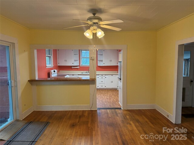 633 Ridge Rd, Marion, NC 28752 - kitchen featuring a sink, baseboards, hardwood / wood-style flooring, a ceiling fan, and white electric stove