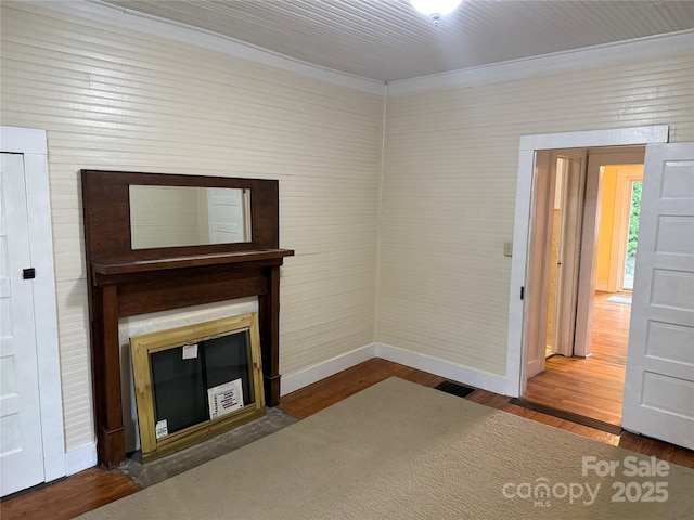 633 Ridge Rd, Marion, NC 28752 - unfurnished living room featuring baseboards, visible vents, ornamental molding, and wood finished floors
