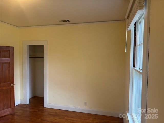 633 Ridge Rd, Marion, NC 28752 - unfurnished bedroom with visible vents, crown molding, a closet, wood finished floors, and baseboards