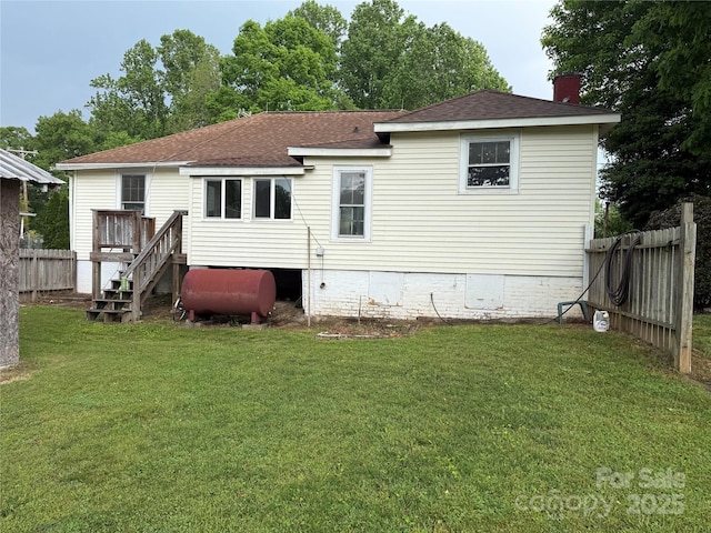 633 Ridge Rd, Marion, NC 28752 - rear view of property with fence, a shingled roof, heating fuel, a chimney, and a yard