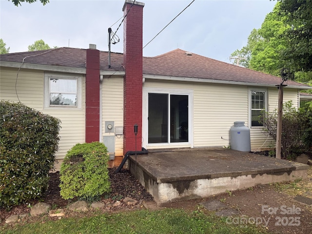633 Ridge Rd, Marion, NC 28752 - rear view of property featuring a shingled roof, a patio area, and a chimney