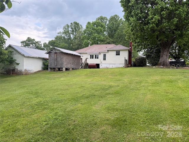 633 Ridge Rd, Marion, NC 28752 - back of house featuring a lawn and an outbuilding