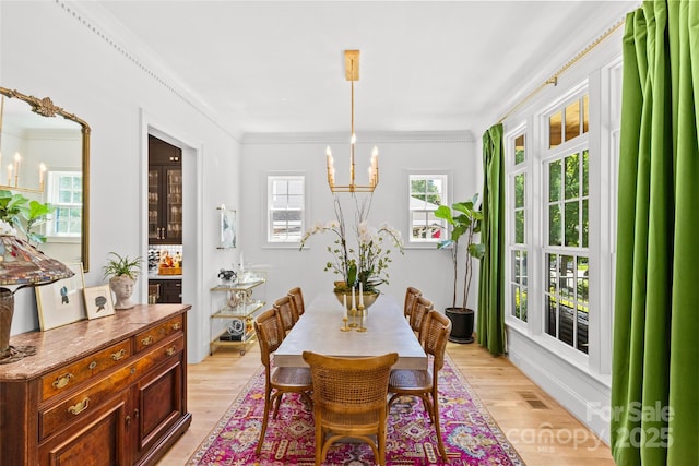 2509 Bay St, Charlotte, NC 28205 - dining room with a chandelier, light wood finished floors, and crown molding