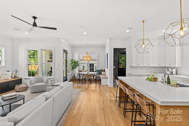 2509 Bay St, Charlotte, NC 28205 - living room featuring recessed lighting, light wood-style flooring, ceiling fan, and crown molding