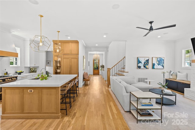 2509 Bay St, Charlotte, NC 28205 - kitchen featuring a sink, open floor plan, light countertops, light wood-style flooring, and recessed lighting