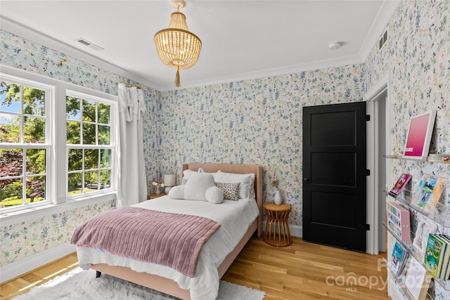 2509 Bay St, Charlotte, NC 28205 - bedroom with wallpapered walls, wood finished floors, a chandelier, baseboards, and crown molding