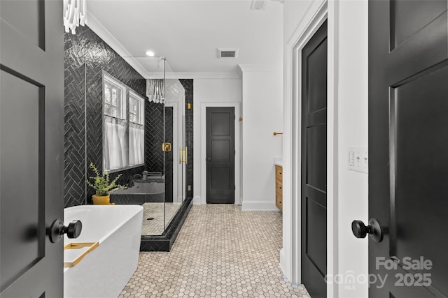 2509 Bay St, Charlotte, NC 28205 - bathroom with crown molding, a stall shower, a freestanding tub, tile patterned floors, and a chandelier
