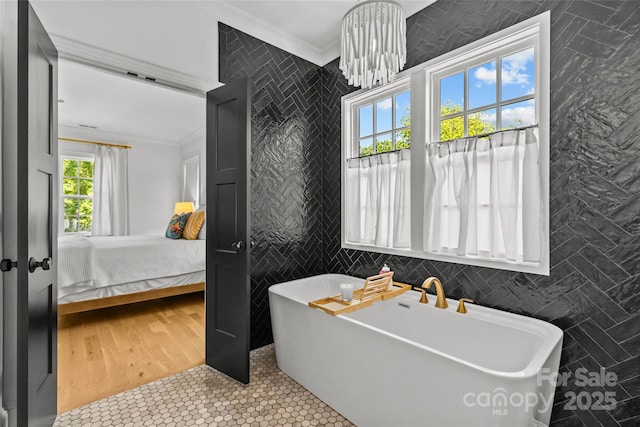 2509 Bay St, Charlotte, NC 28205 - ensuite bathroom featuring tile walls, ornamental molding, a freestanding bath, and tile patterned floors